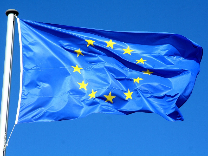 The EU flag on a bright sunny day with blue sky.