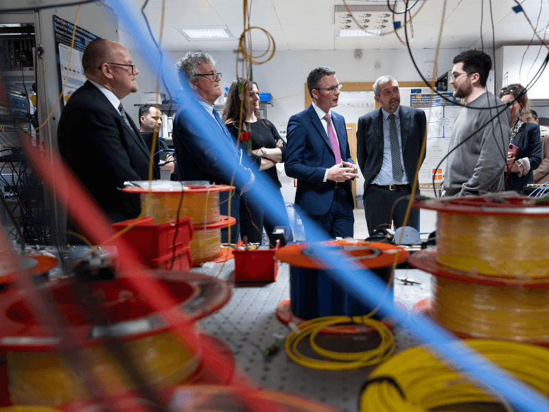 Minister Patrick O'Donovan speaking with researchers at Tyndall National Institute