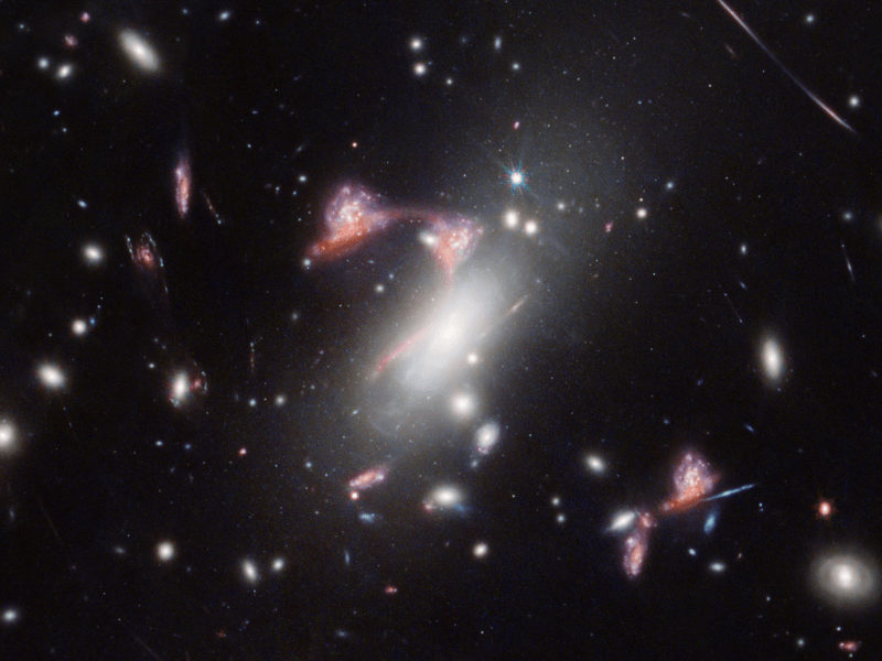 An image of multiple galaxies in space, forming the shape of a question mark. Taken by the James Webb Space Telescope.