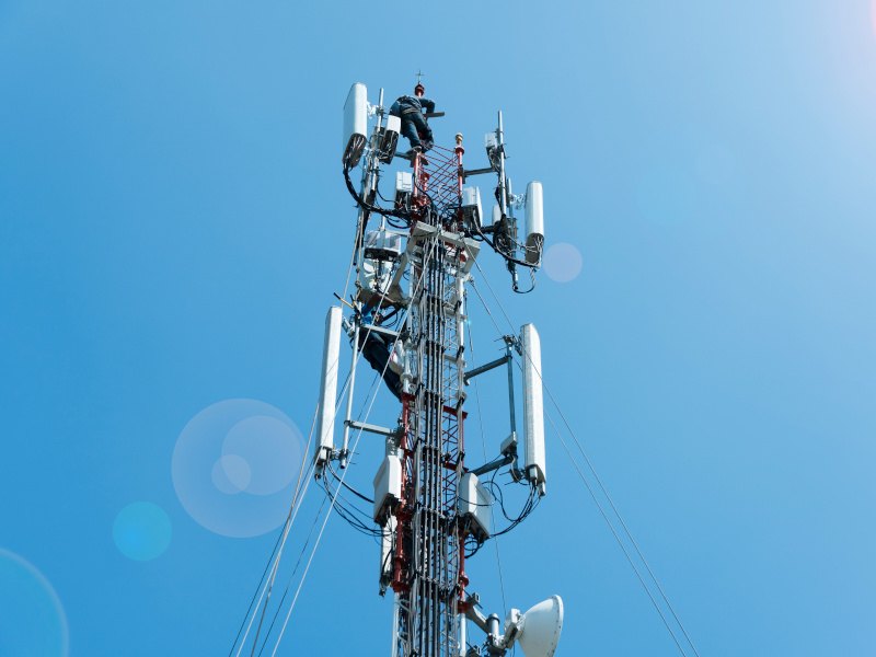 Bright blue sky and a 5G telecom tower.