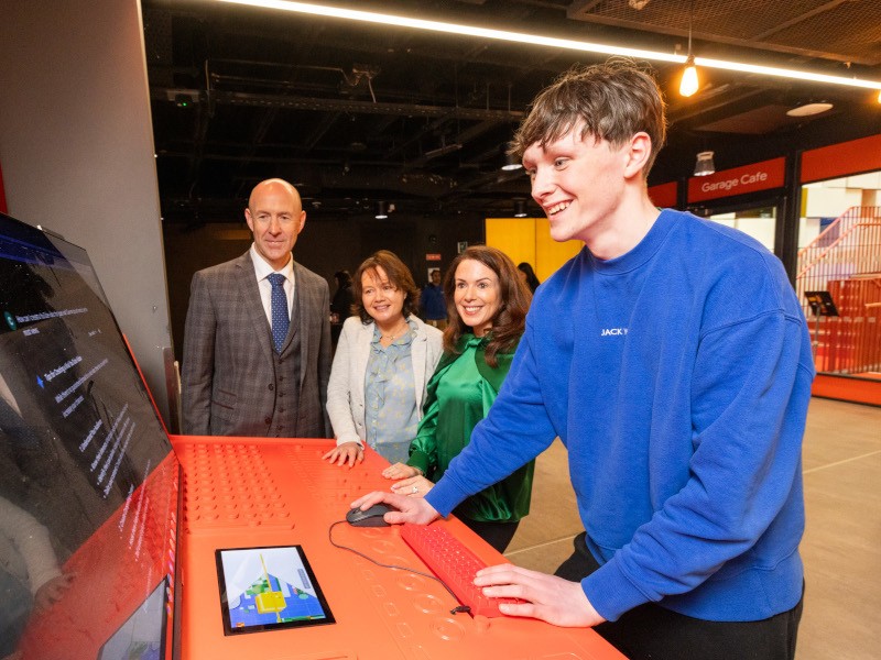 Two women, a man and a teenage boy look at a computer screen in Google's HQ in Dublin.