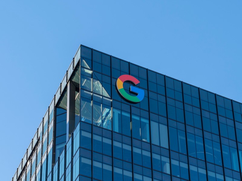 Google 'G' logo on a building with a glass exterior.