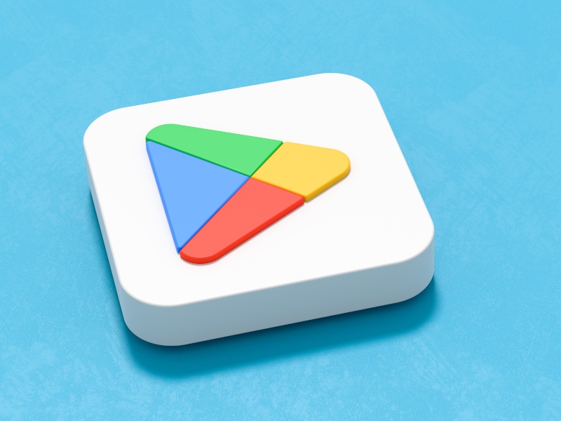 A 3D white tile with the Google Play Store logo on it. The tile sits against a blue background.