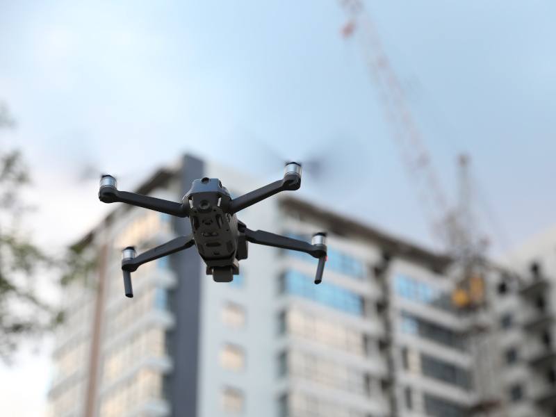 A drone flying near buildings.