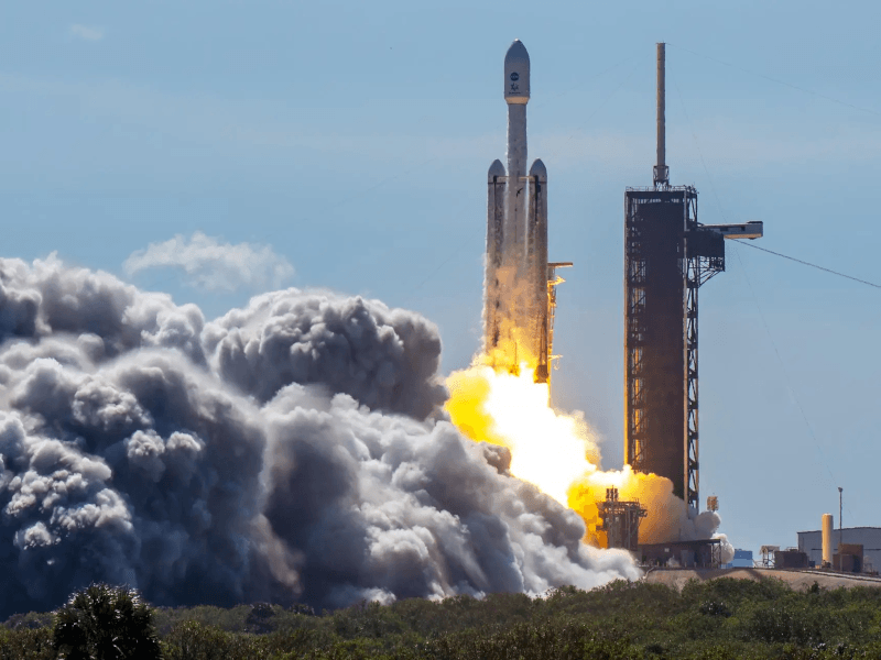 The Europa Clipper spacecraft and SpaceX rocket lift off in blaze of smoke and fire.