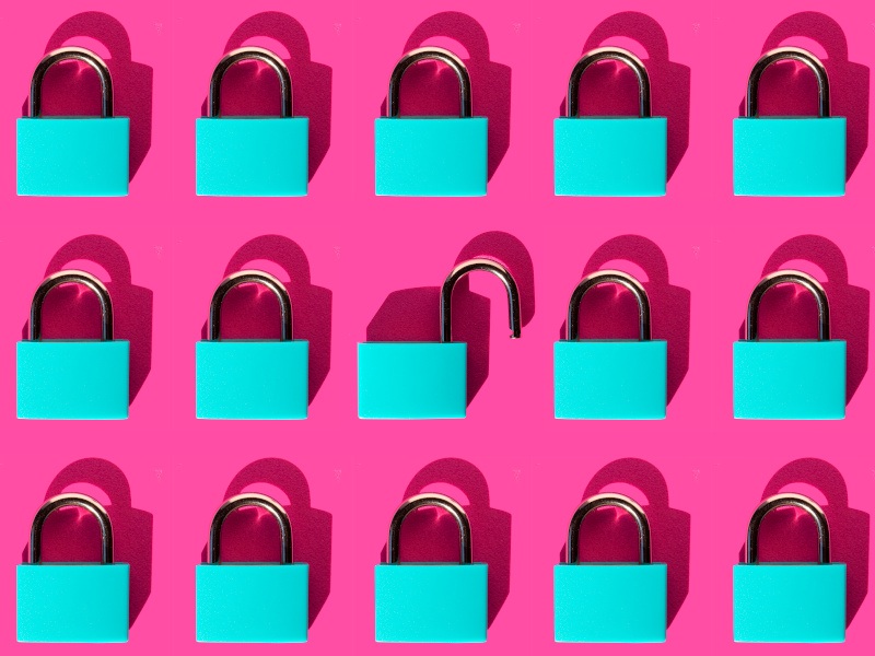 Three rows of five small blue padlocks against a bright pink background. The one in the centre is open, symbolising cybersecurity.