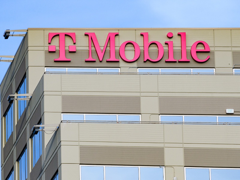 T-mobile logo on a building with a blue sky in the back