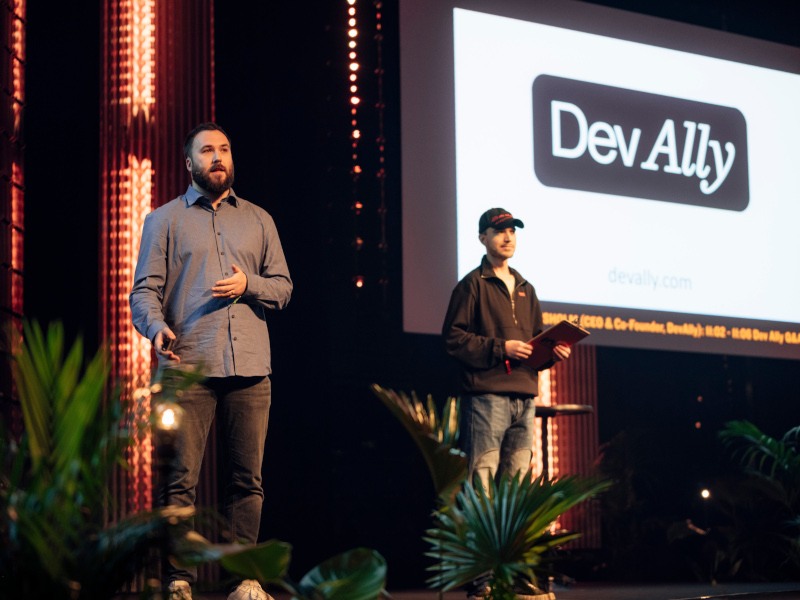 Two men on a stage pitching their product.