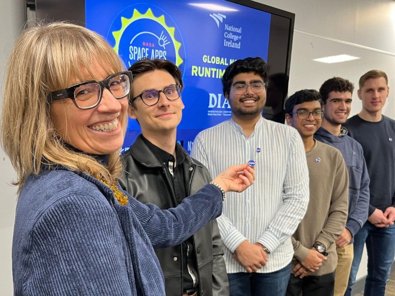 A group of six people stand together smiling at the Dublin NASA Space Apps Challenge event.