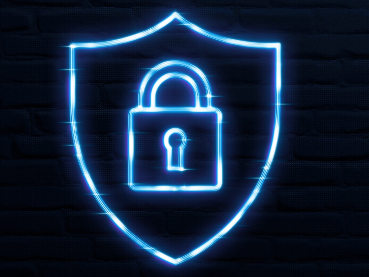 A bright blue outline of a padlock inside a shield, representing cybersecurity.