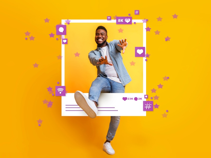 Guy dancing and jumping out of photo frame over yellow studio.